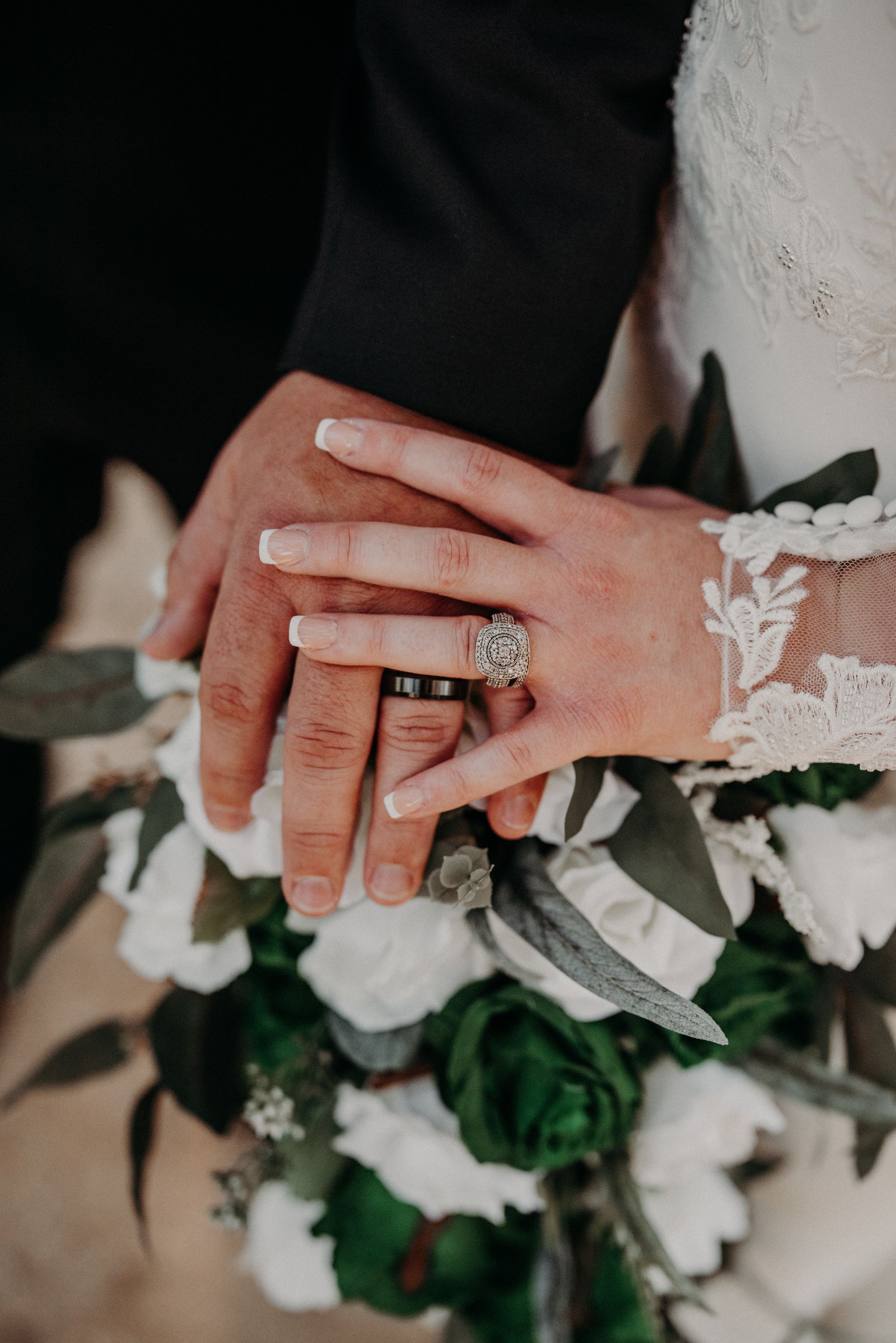 the bride and groom are holding hands during their wedding ceremony