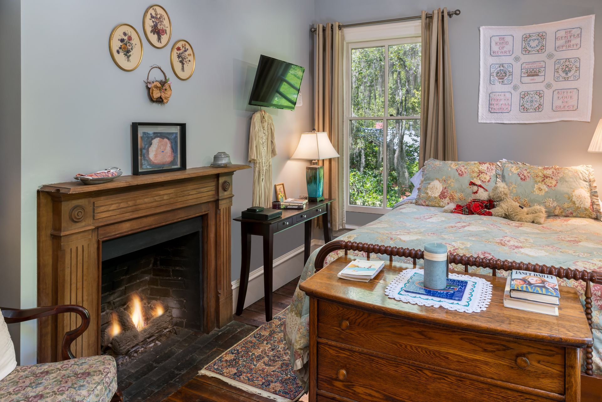 a bedroom with a bed , chair , nightstand , lamp and green walls .