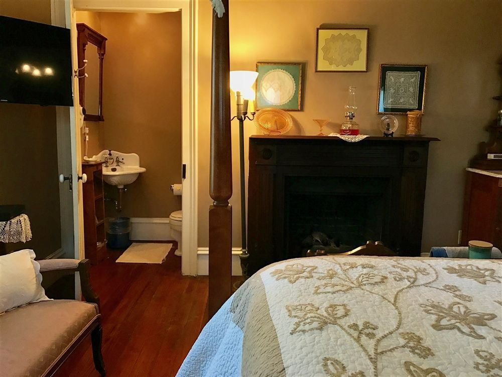 a bedroom with a fireplace and a television