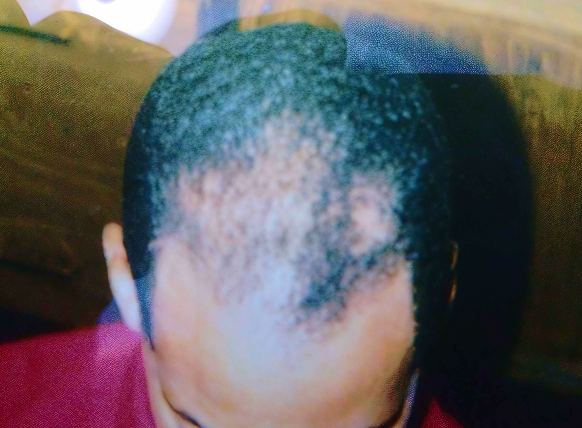 A picture of a man 's head with a clapper board in the background