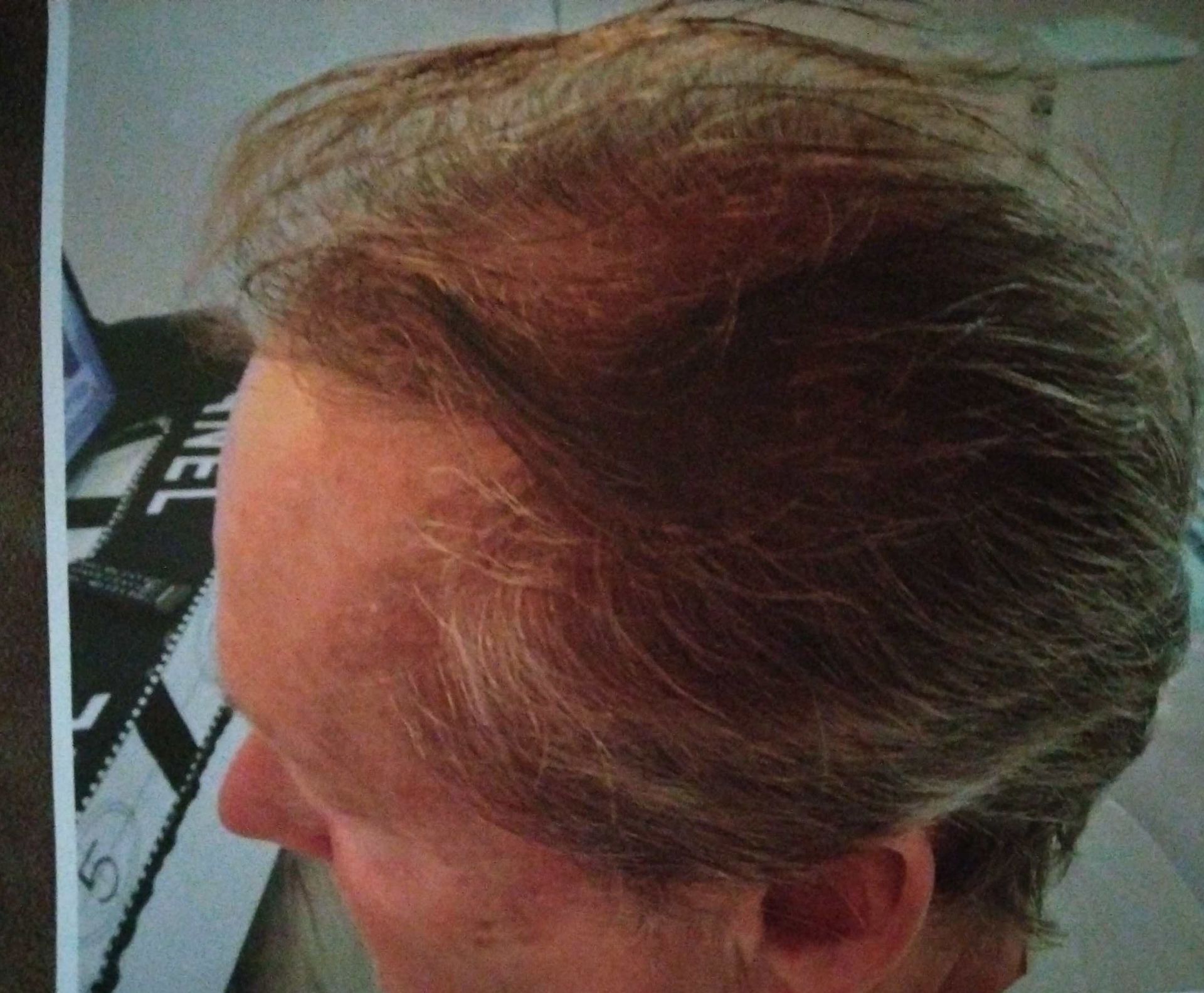 A picture of a man 's head with a clapper board in the background