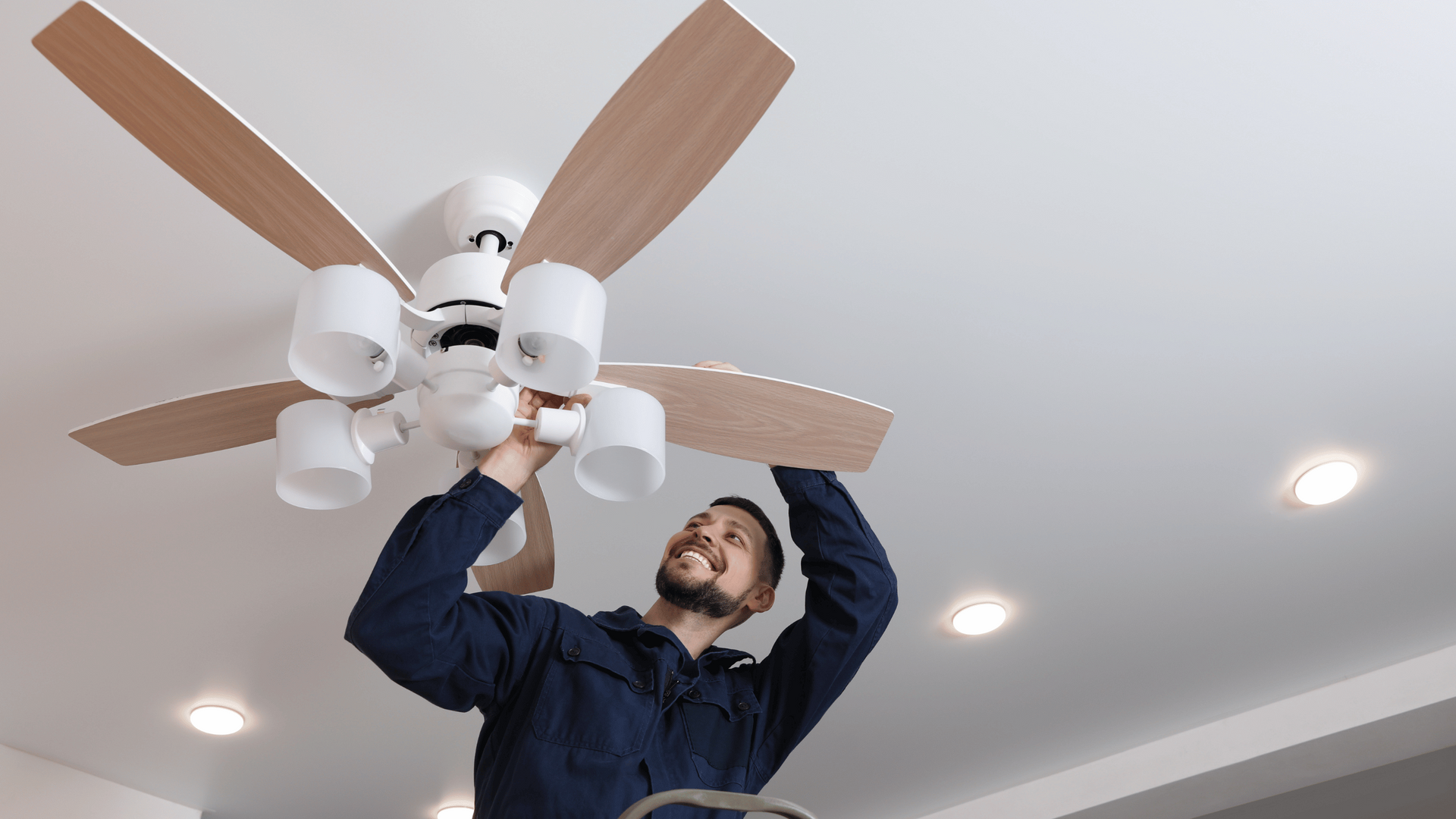 man fixing ceiling fan