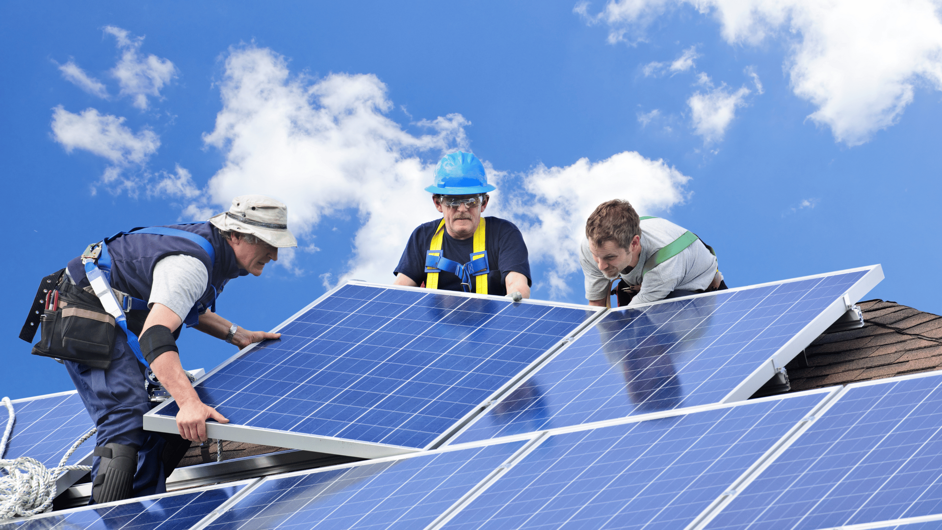 group of men fixing solar panels