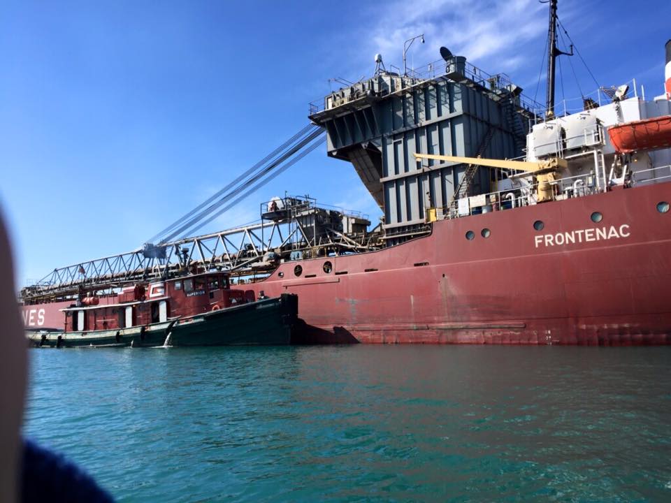 A large red ship with the name frontenac on the side