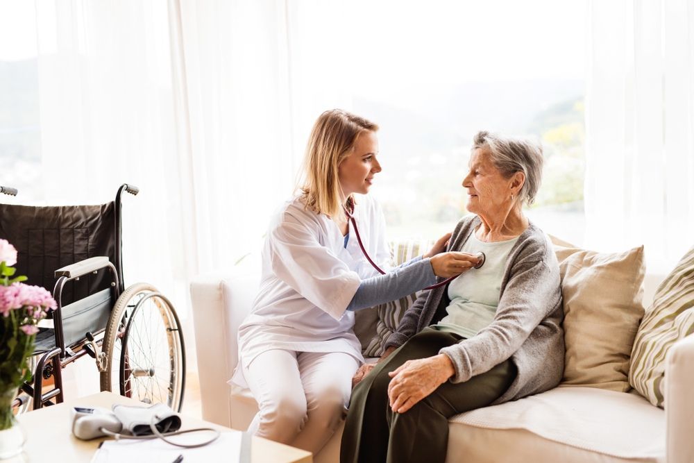 A Nurse is Listening to an Elderly Woman 's Heartbeat With a Stethoscope — One Stop Medical in Mackay, QLD