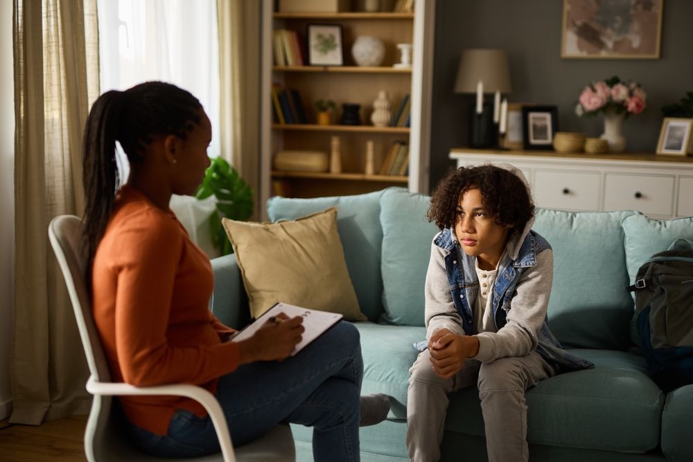 A Man and a Woman Are Sitting at a Table Talking to a Woman — One Stop Medical in Mackay, QLD