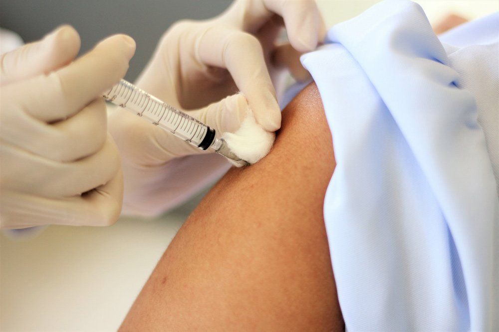 A Person is Getting an Injection in Their Arm — One Stop Medical in Mackay, QLD