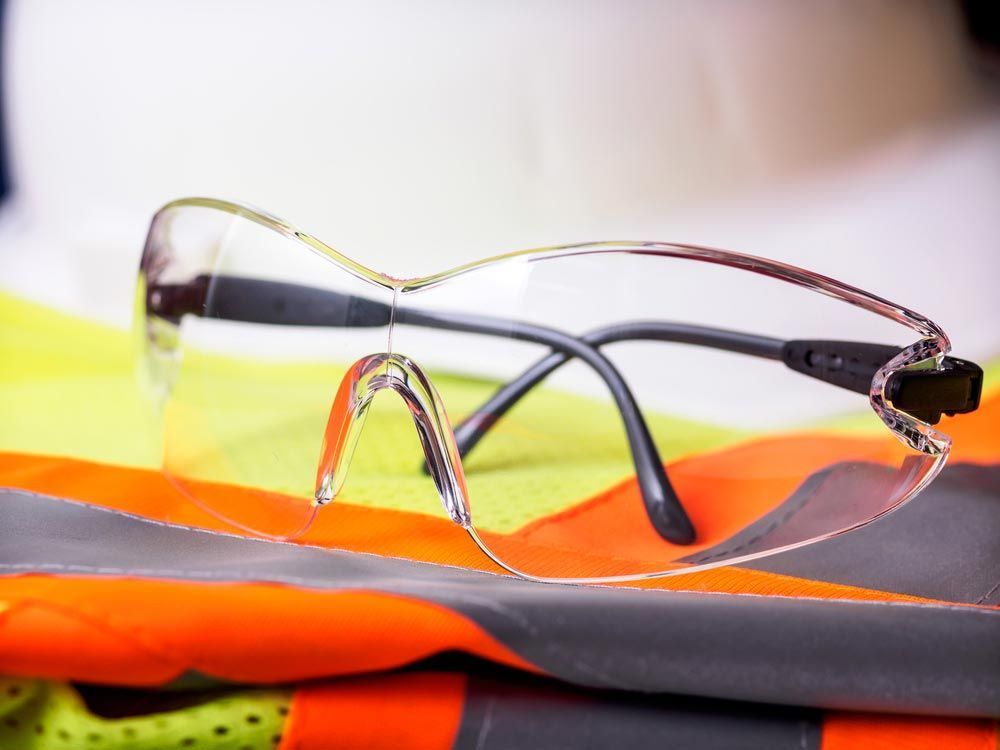 A Pair of Safety Glasses Sitting on Top of a Safety Vest.— One Stop Medical in Mackay, QLD