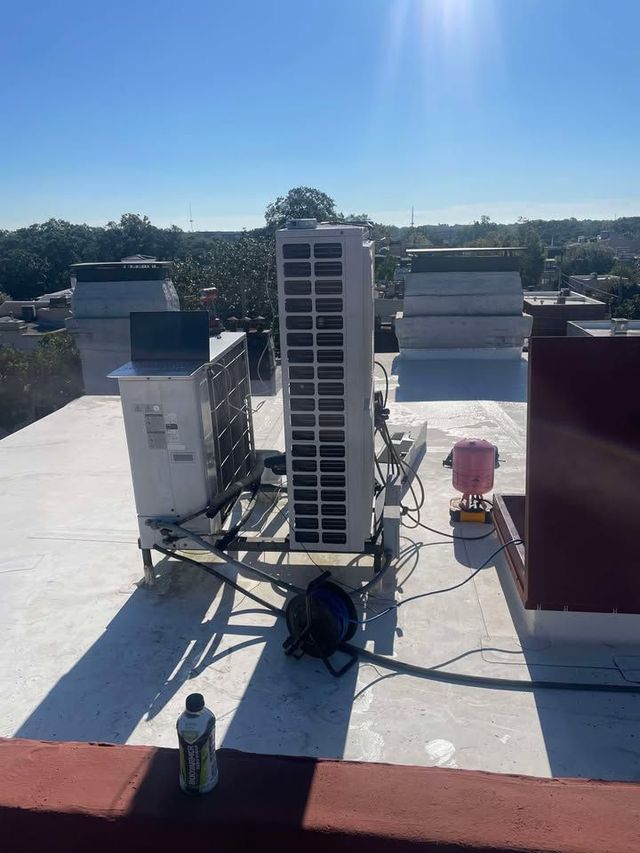 HVAC units on a rooftop against a clear, sunny sky.
