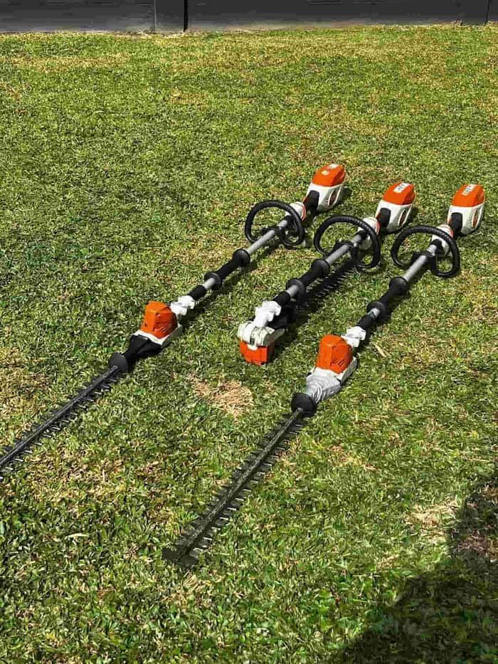 Three Cordless Hedge Trimmers on Grass — Mow & Mulch Lawn & Garden Maintenance In White Rock, QLD