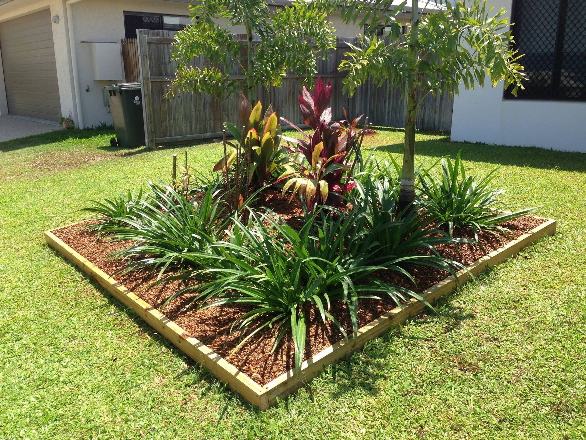 A Clean Colourful Garden In A Neat Garden Bed On The Front Lawn — Mow & Mulch Lawn & Garden Maintenance In White Rock, QLD