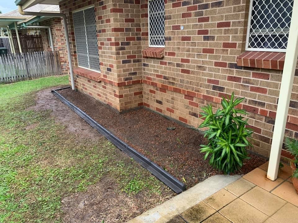 Brick Building With a Gravel Bed and Small Plant — Mow & Mulch Lawn & Garden Maintenance In White Rock, QLD