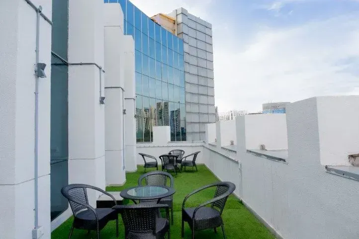 Commercial rooftop patio with artificial turf and seating.