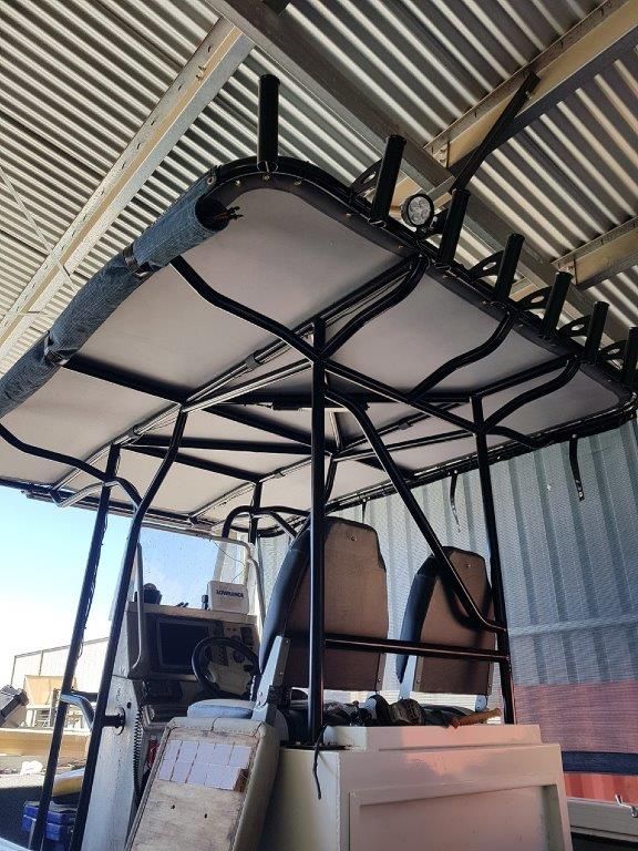 A boat with a roof that is hanging from the ceiling