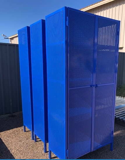 A row of blue lockers are lined up next to each other