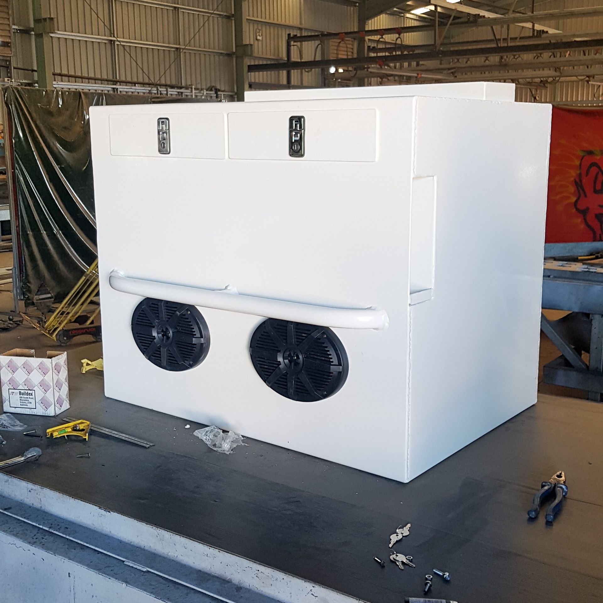 A white box with two speakers on it is sitting on a table