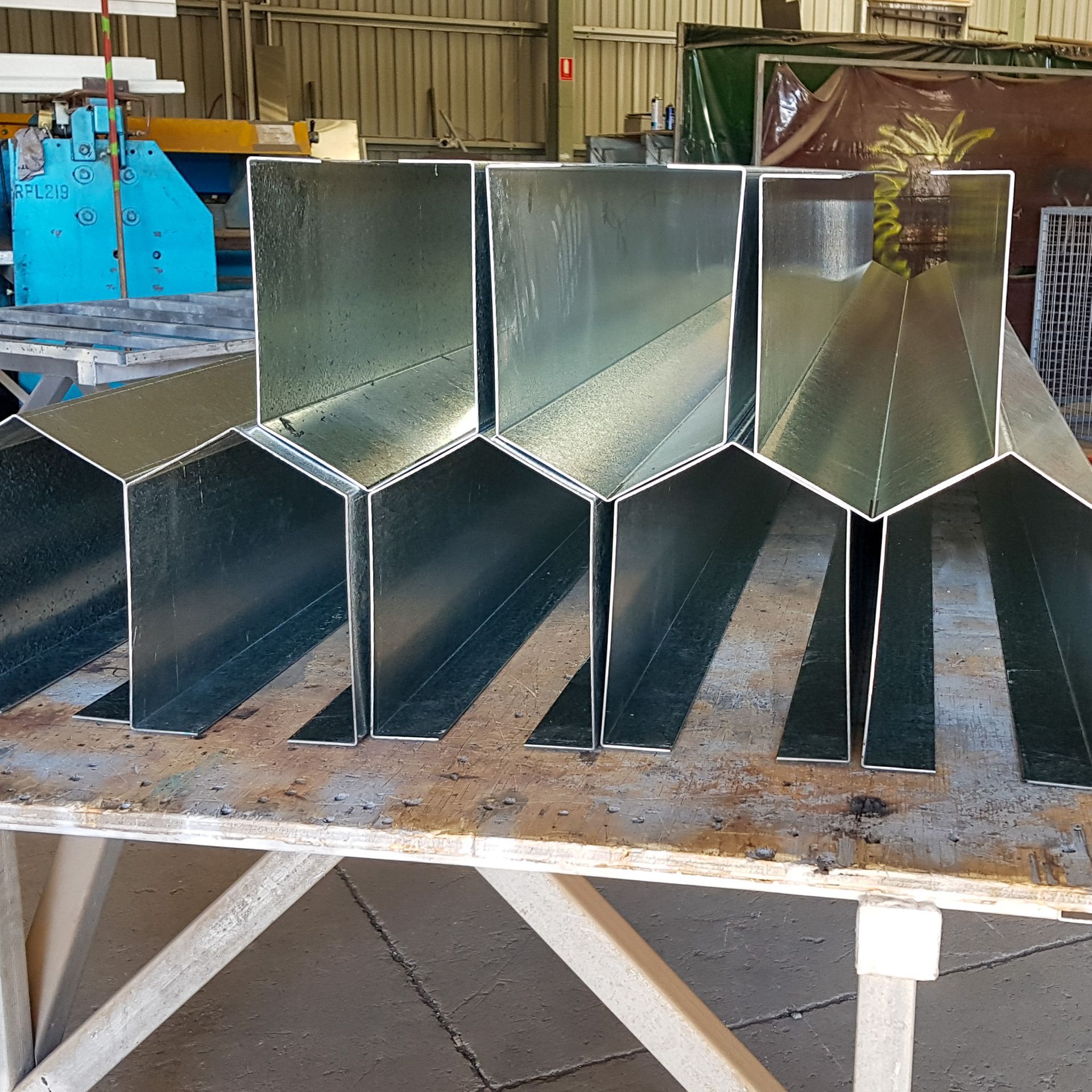 A bunch of metal pieces are lined up on a table