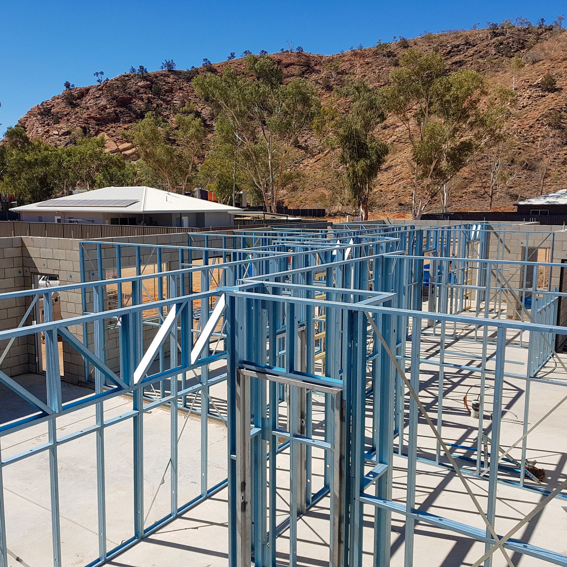 A building under construction with a mountain in the background