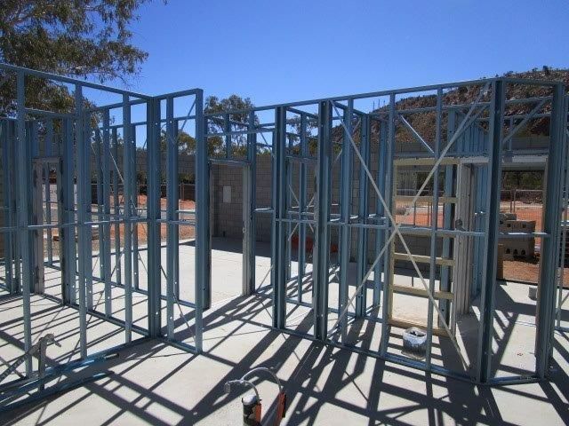 A building under construction with a blue sky in the background