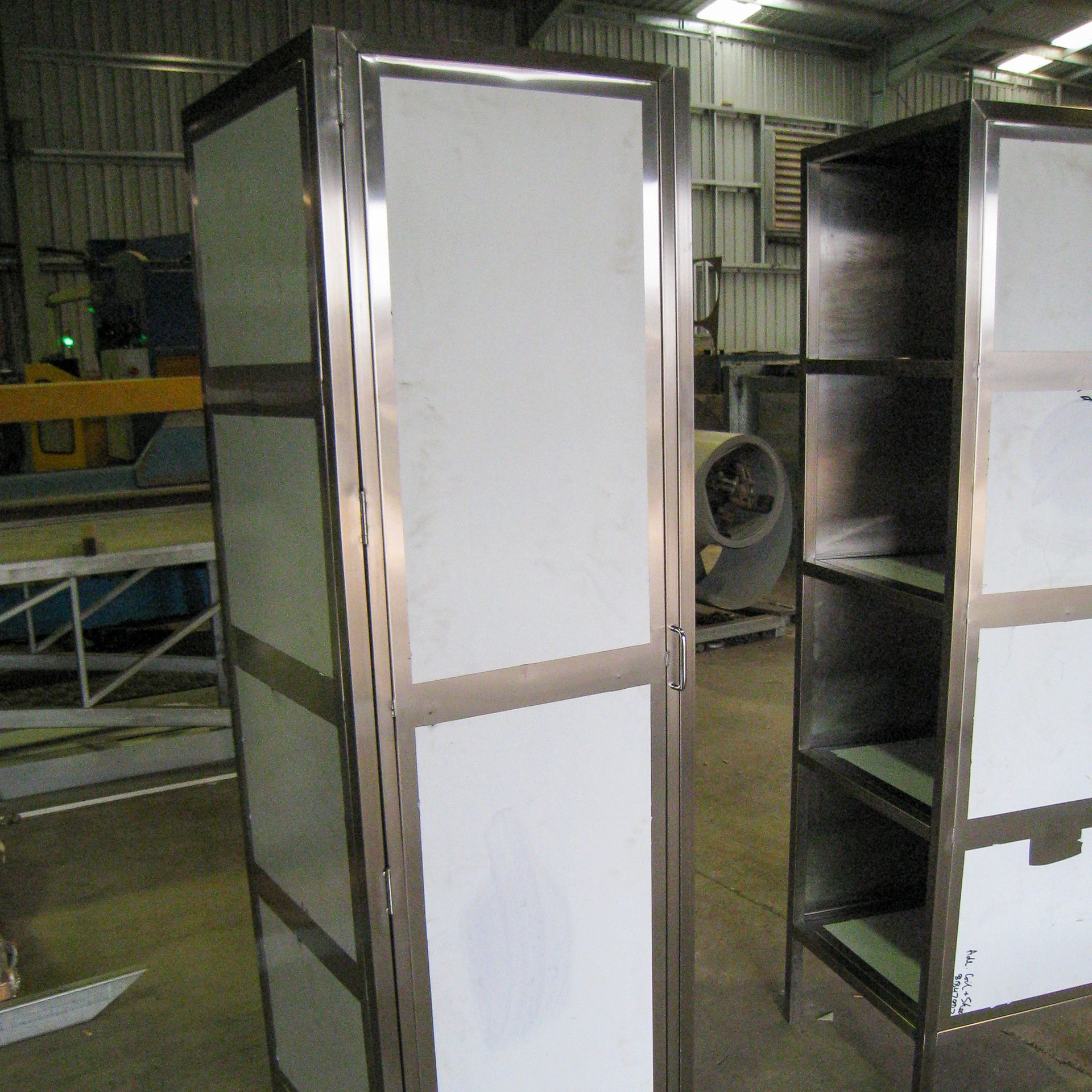 Two stainless steel cabinets are sitting next to each other