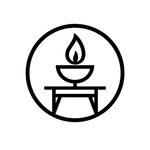 Candle flame in a bowl atop a table, enclosed in a circle.
