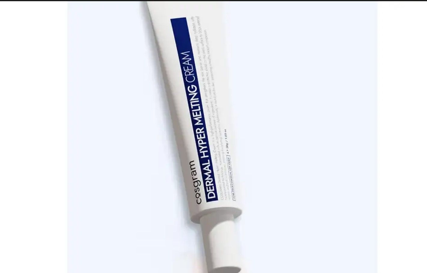 A tube of dermal hyper molding cream is sitting on a white surface.