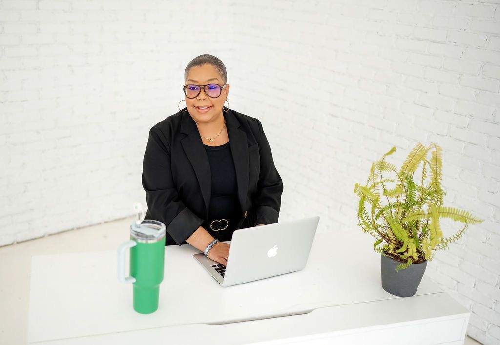 a woman in black underwear is posing for a picture .