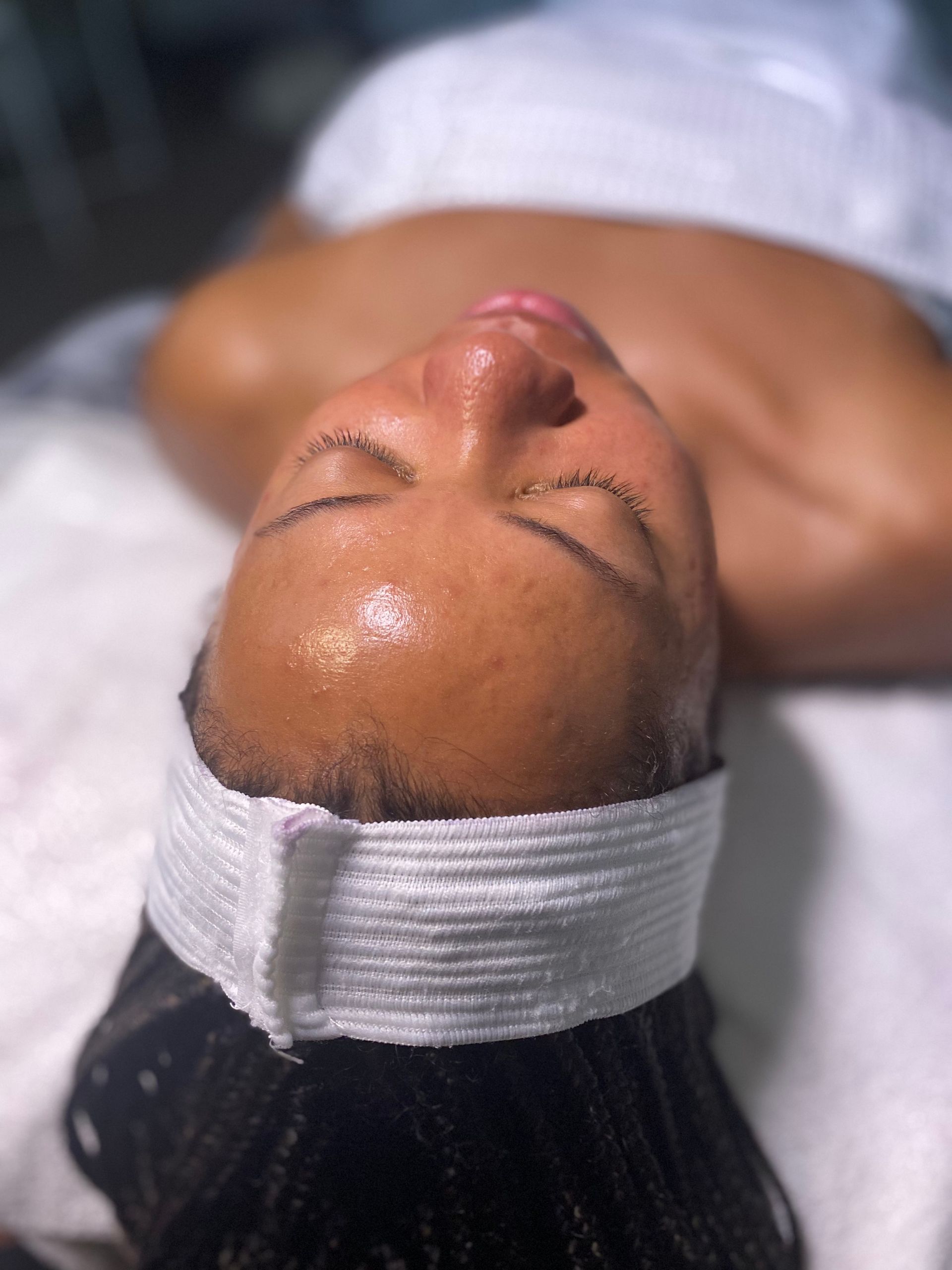 A woman is getting a facial treatment at a spa.