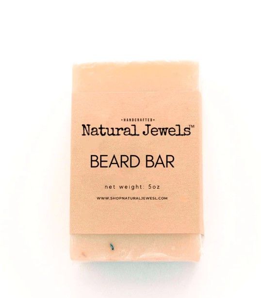 A natural jewels beard bar is sitting on a white surface.