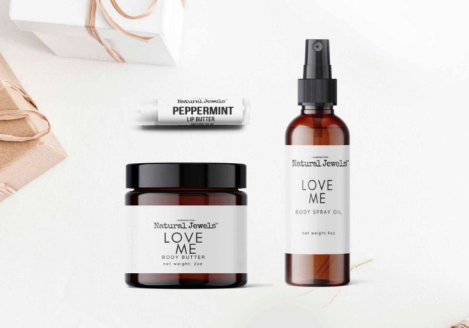 a bottle of spray , a lip balm , and a jar of cream are sitting on a table .