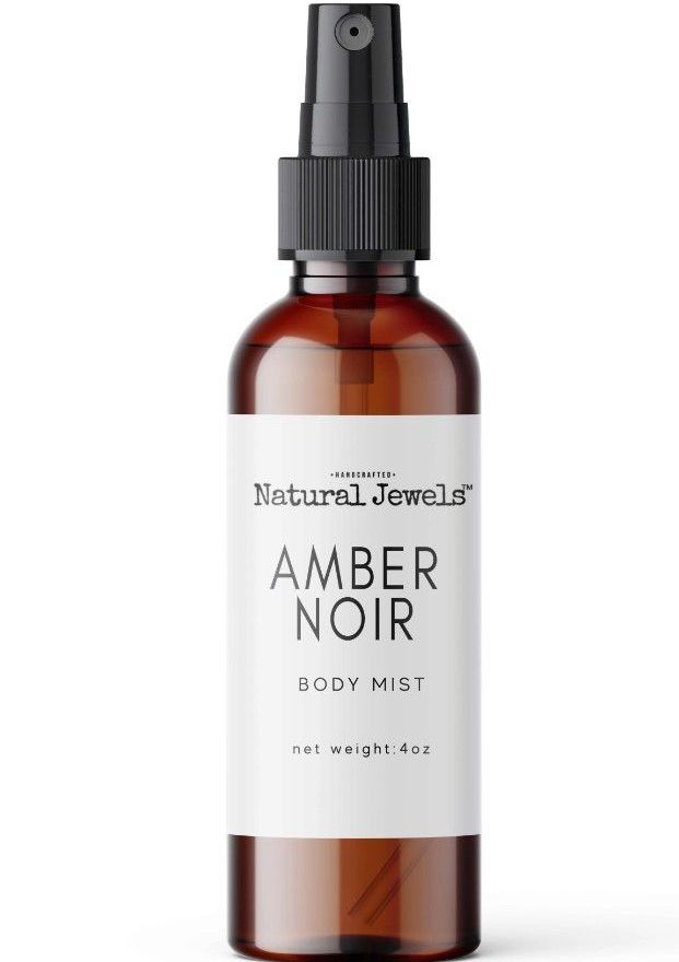 a brown bottle of amber noir body mist on a white background .