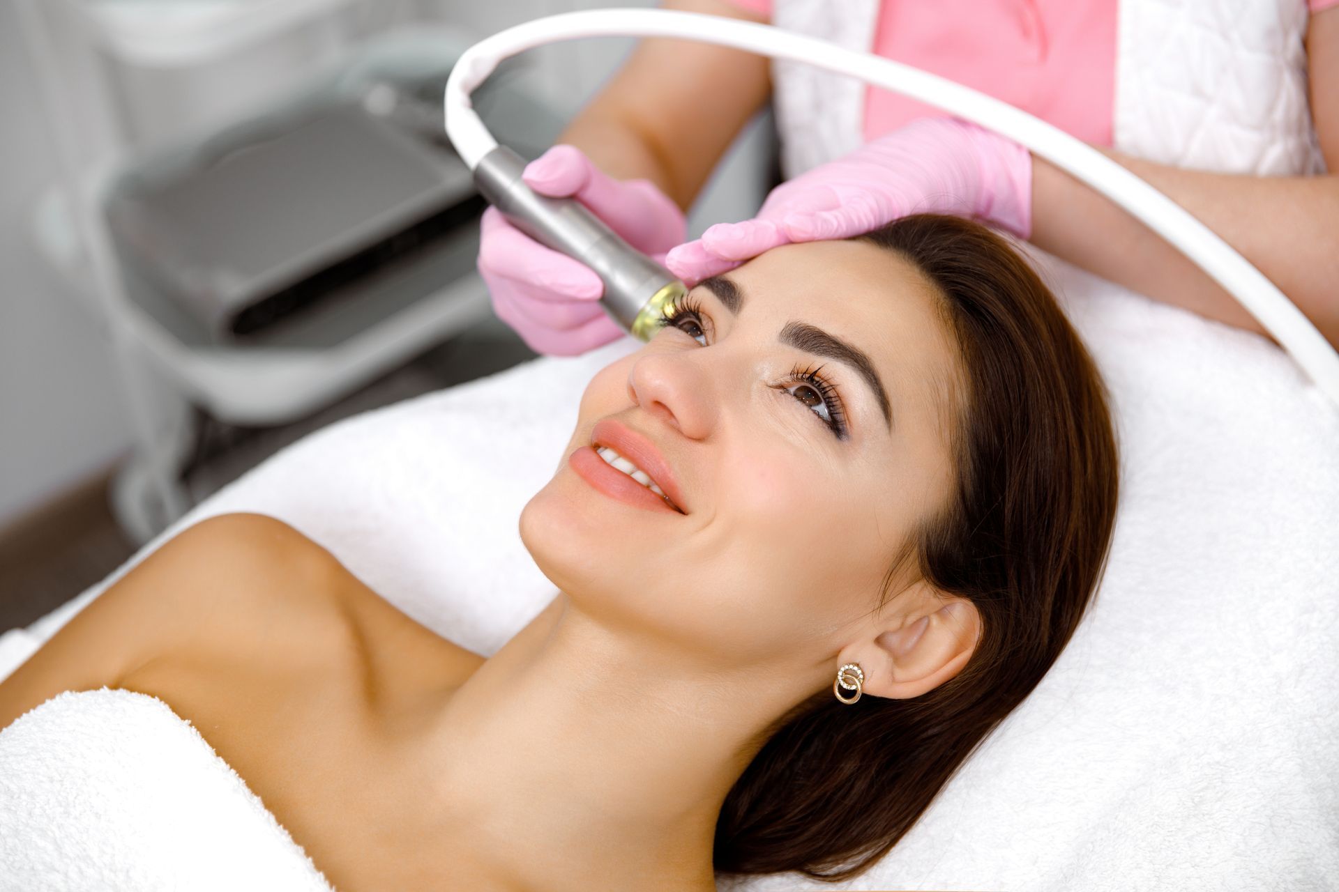 a woman is getting a facial treatment at a beauty salon .