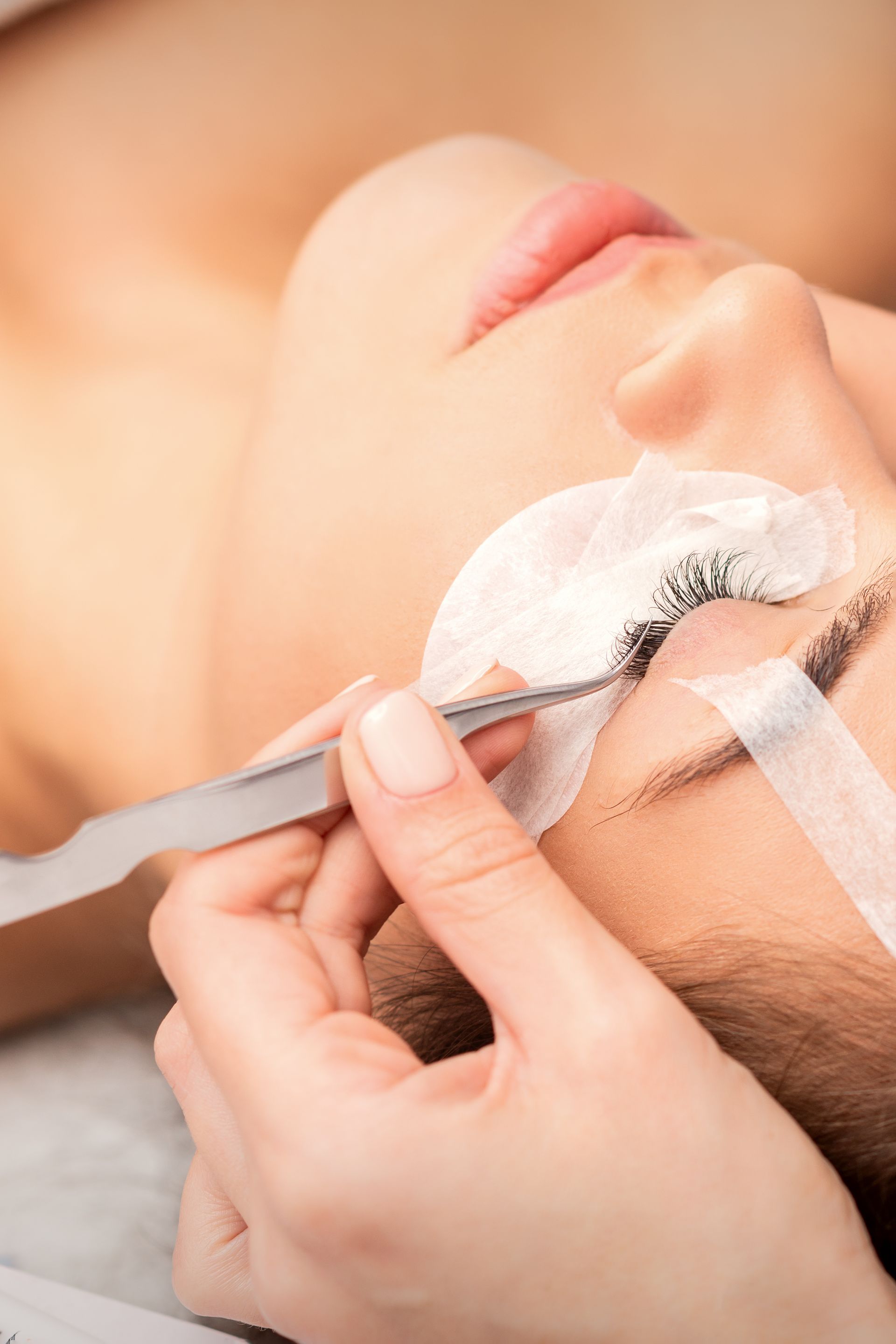 a woman is getting eyelash extensions in a beauty salon .