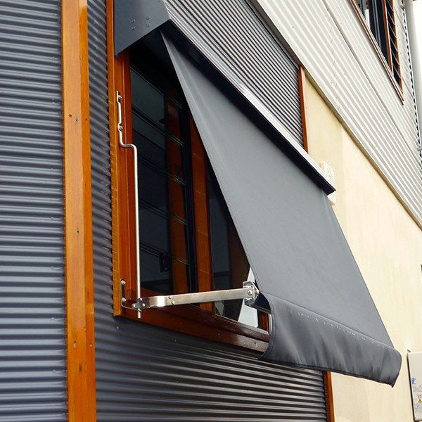 A Window With A Black Awning On It — Spring Crest Blinds, Awnings & Security Doors in Golden Square, VIC