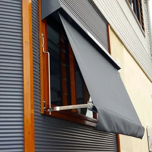 A Window With A Black Awning On It — Spring Crest Blinds, Awnings & Security Doors in Golden Square, VIC