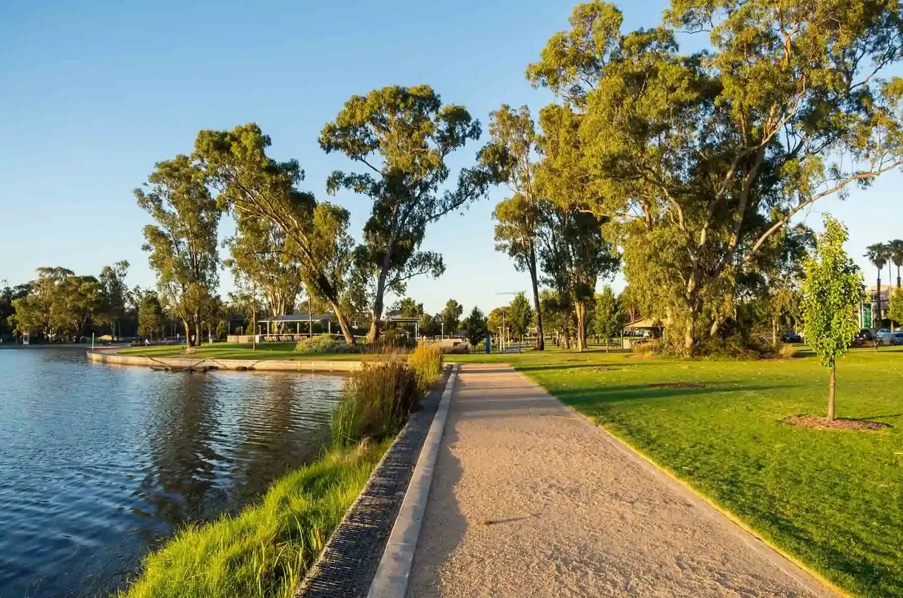 A Path Leading To A Lake Surrounded By Trees And Grass — Spring Crest Blinds, Awnings & Security Doors in Shepparton, VIC