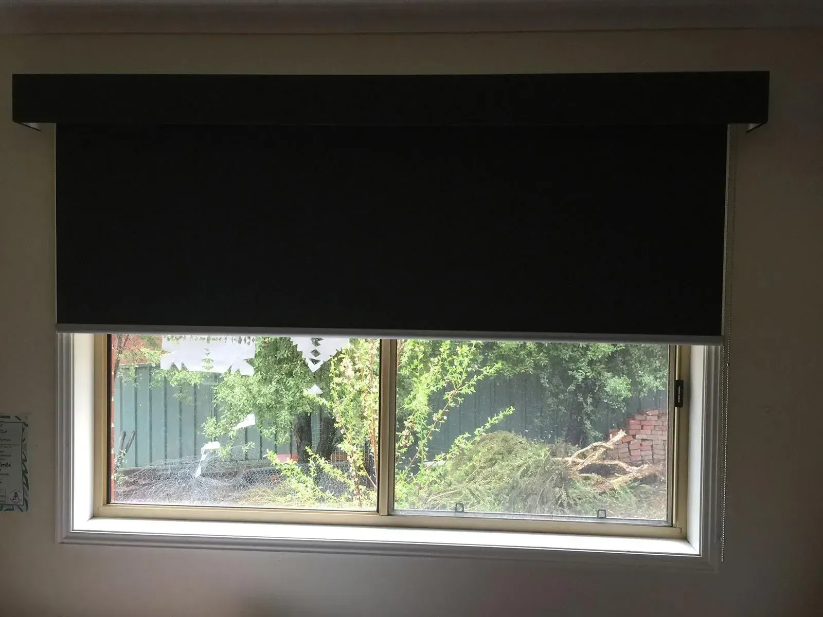 A Large Window With A Black Blind On It — Spring Crest Blinds, Awnings & Security Doors in Golden Square, VIC