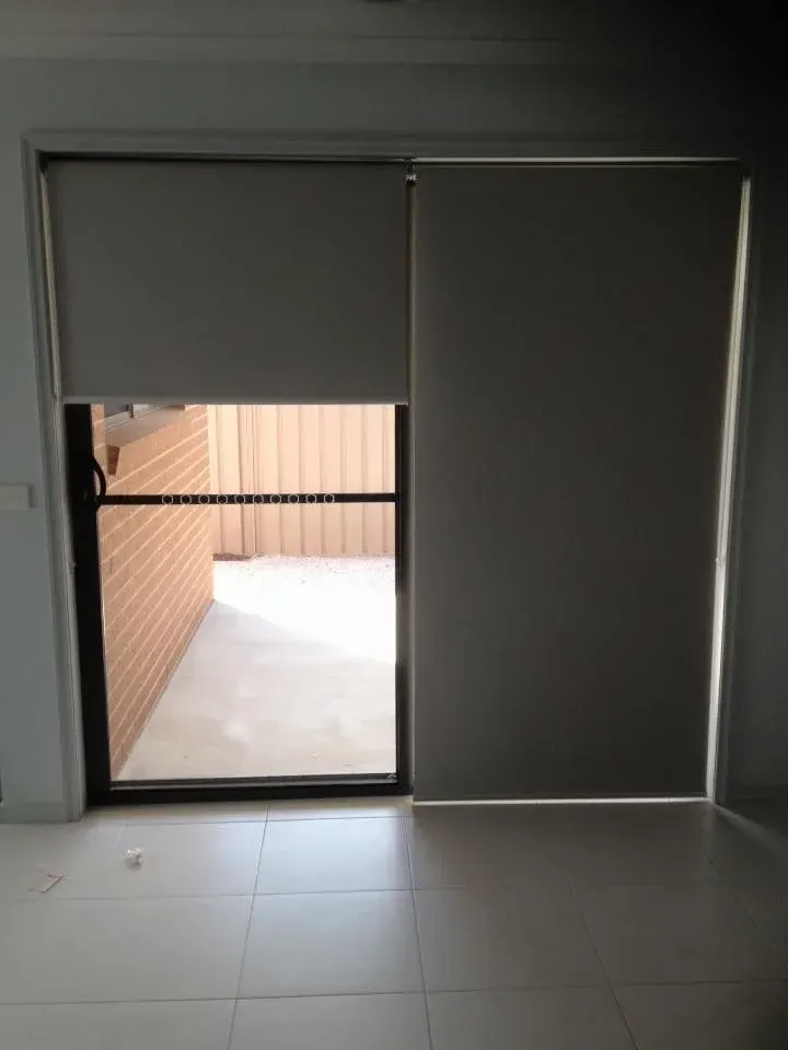 A Room With A Sliding Glass Door And Blinds On It — Spring Crest Blinds, Awnings & Security Doors in Golden Square, VIC