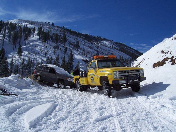 Towing Fleet — Yellow Tow Truck on Snow Road in Reno, NV