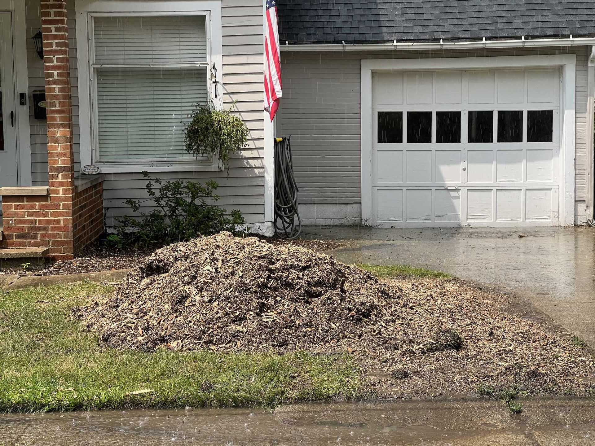 A house with a large pile of dirt in front of it
