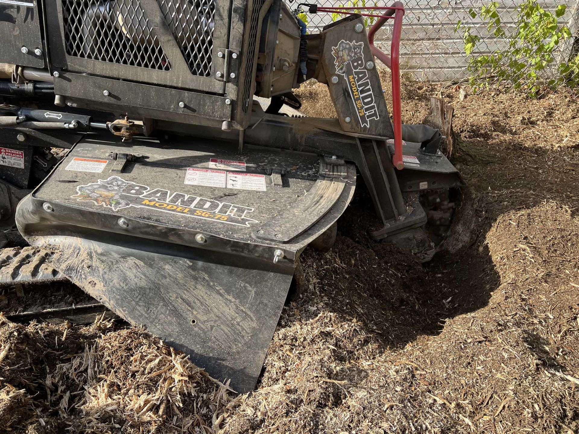 A stump grinder is being used to remove a tree stump.