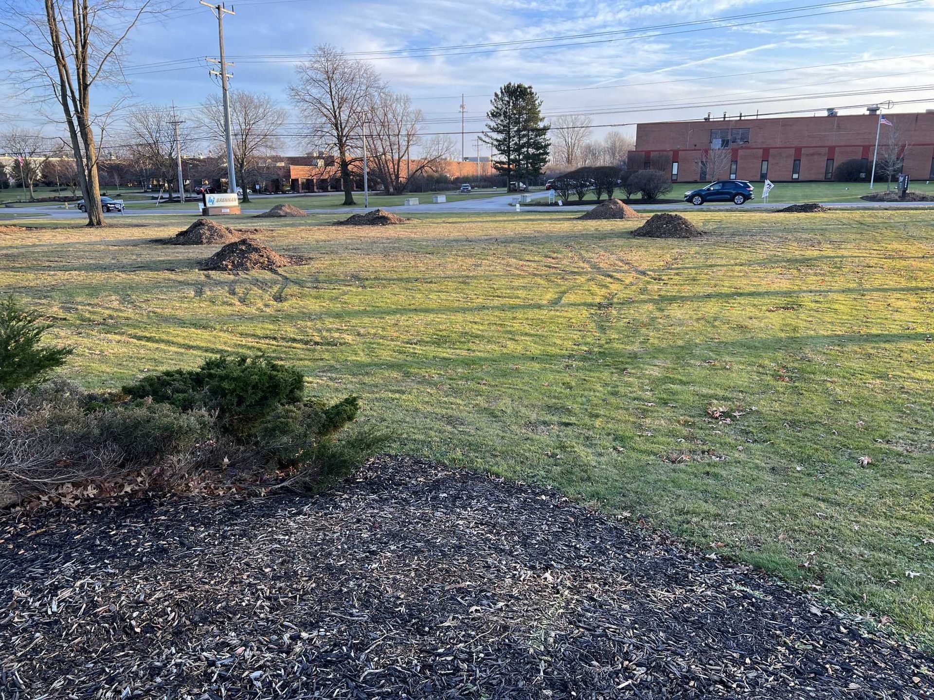 A large grassy field with a building in the background.