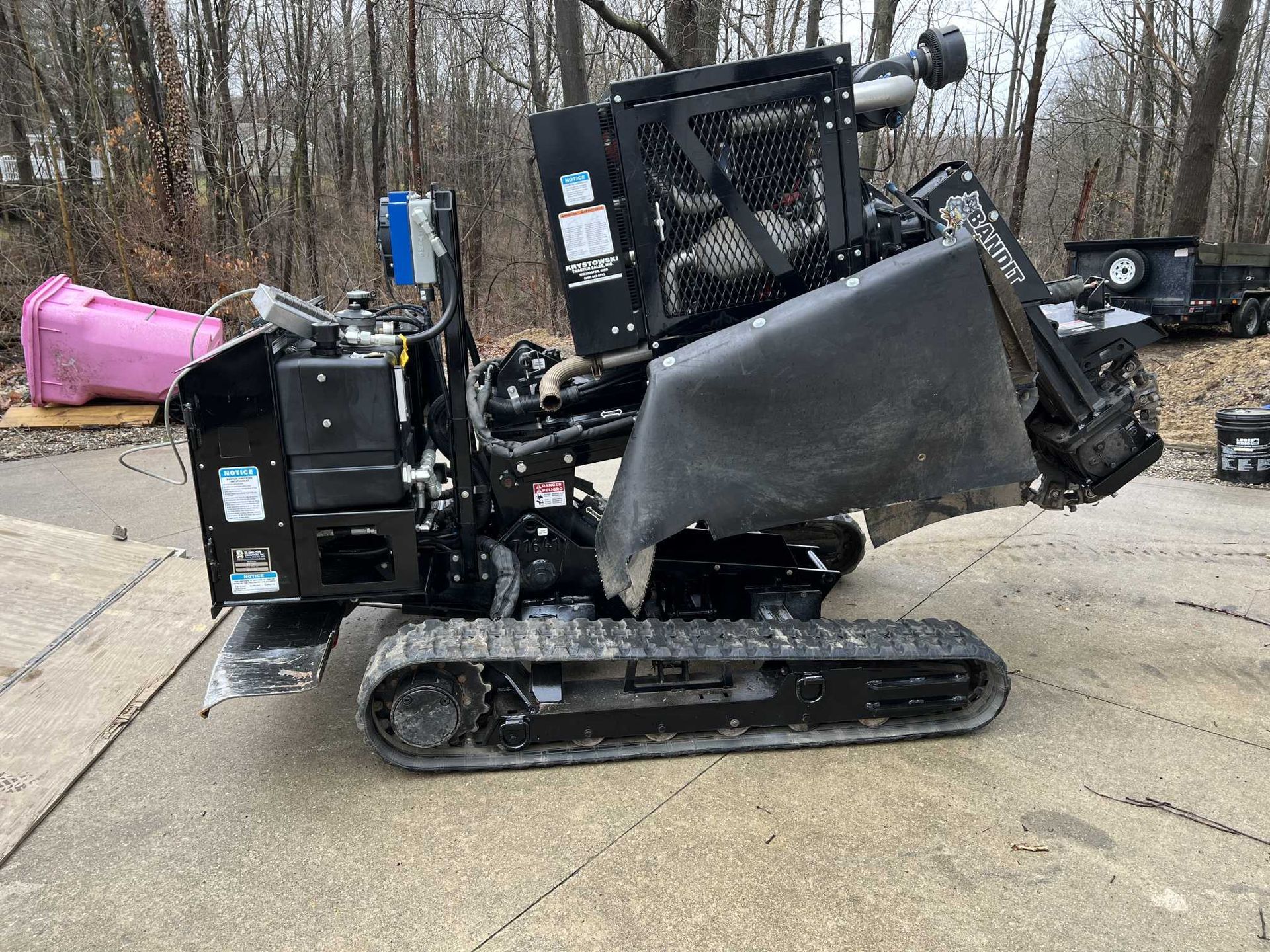 A black tractor is parked on the side of the road.
