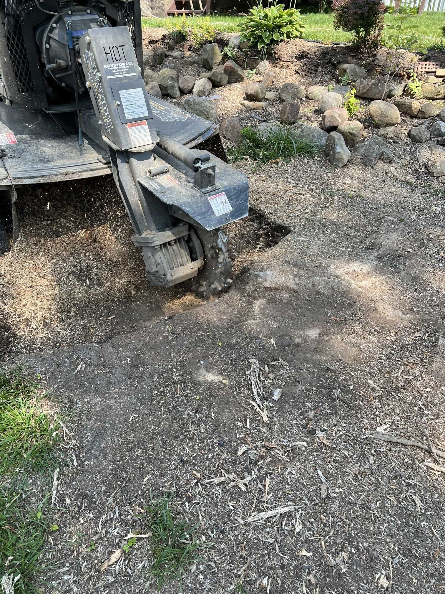 A stump grinder is being used to remove a tree stump.