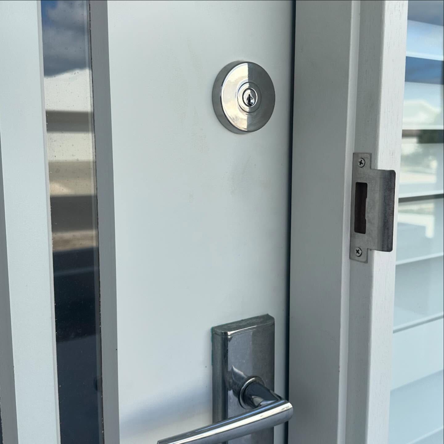 White Door With Chrome Hardware: Deadbolt, Handle, and Strike Plate — Great Ocean Locksmiths in Belmont, VIC