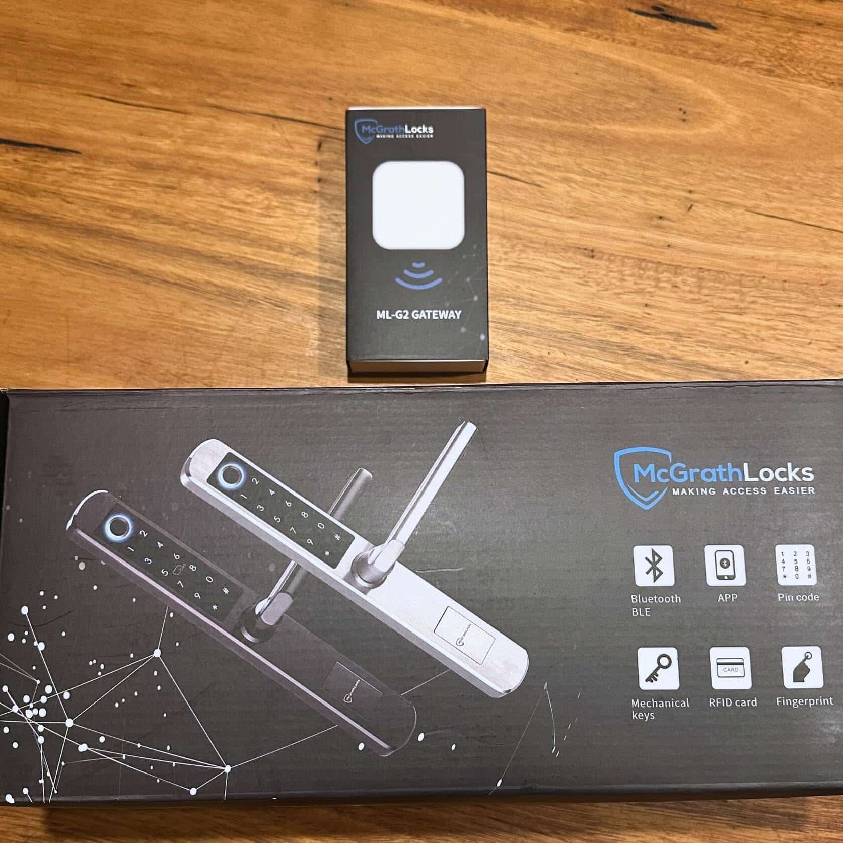 McGrath Locks Smart Lock Box and Key Fob on a Wooden Table — Great Ocean Locksmiths in Belmont, VIC