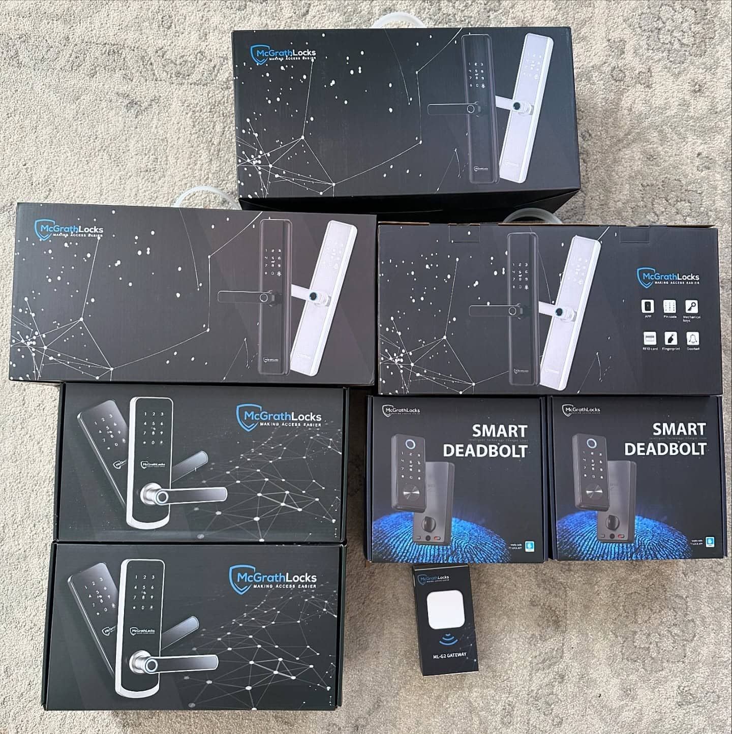 Various Black Boxes of Smart Locks and Deadbolts on a Surface — Great Ocean Locksmiths in Anglesea, VIC