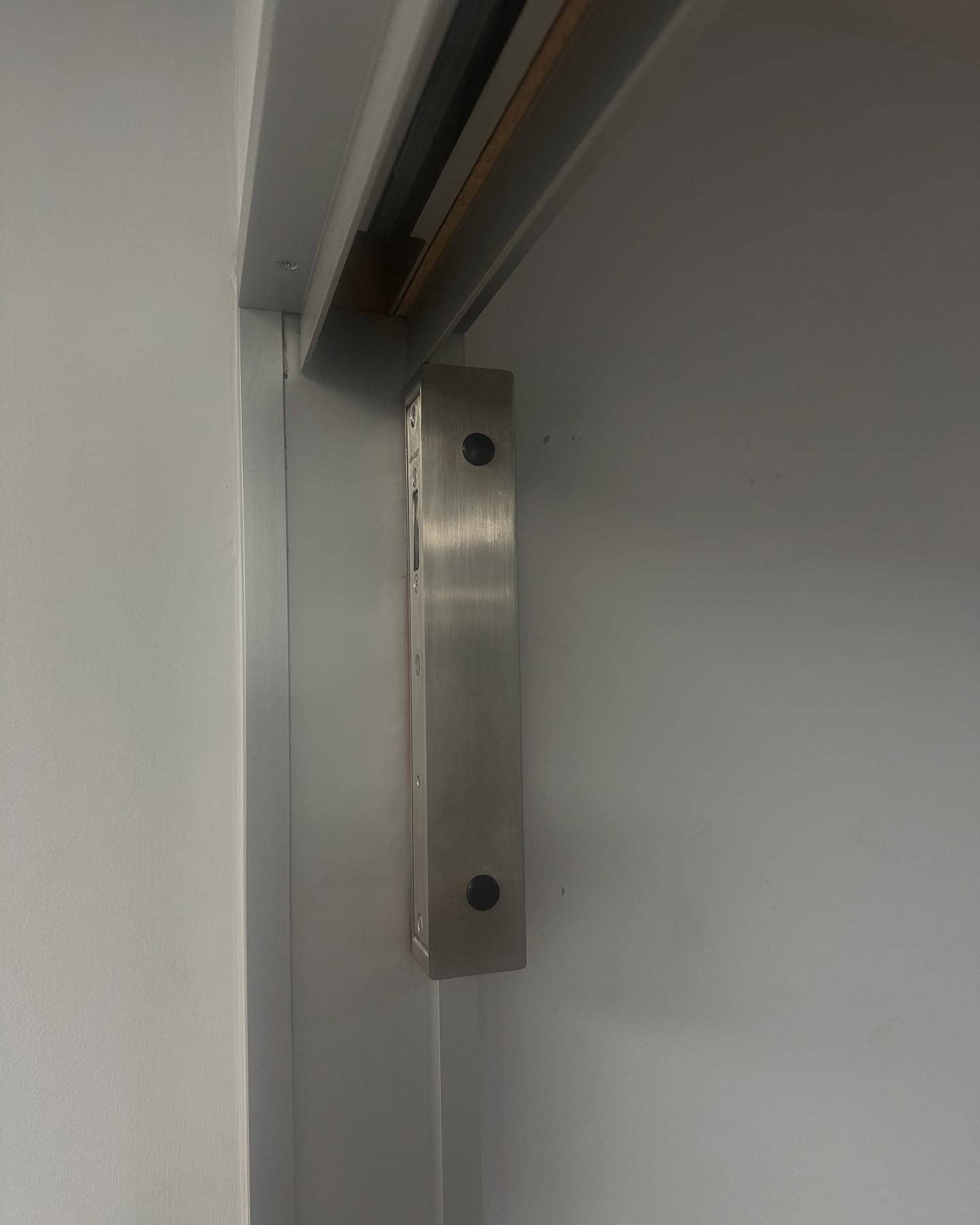 Silver Magnetic Door Lock on a White Door Frame — Great Ocean Locksmiths in Aireys Inlet, VIC
