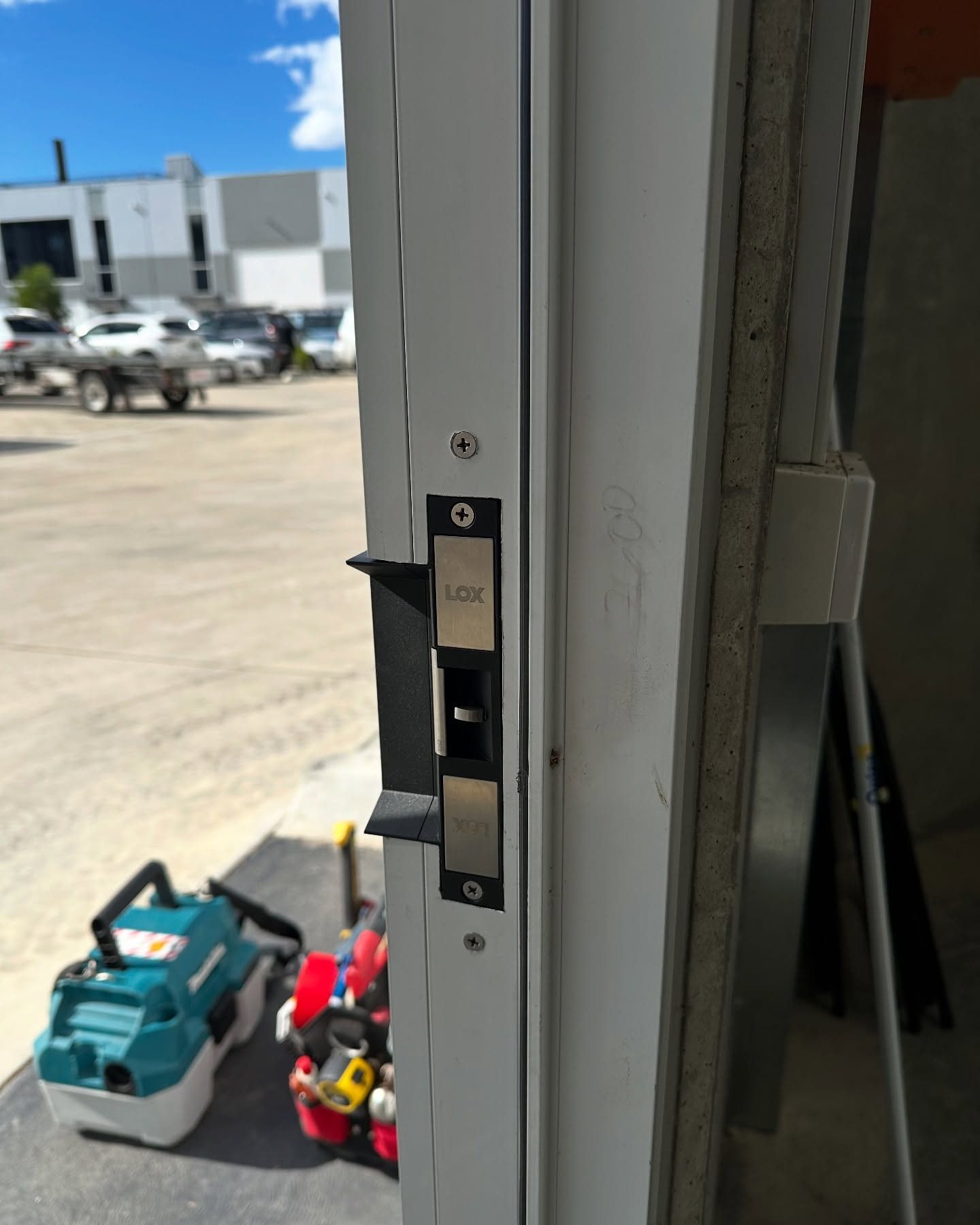 White Door Frame With a Black and Silver Door Lock — Great Ocean Locksmiths in Torquay, VIC