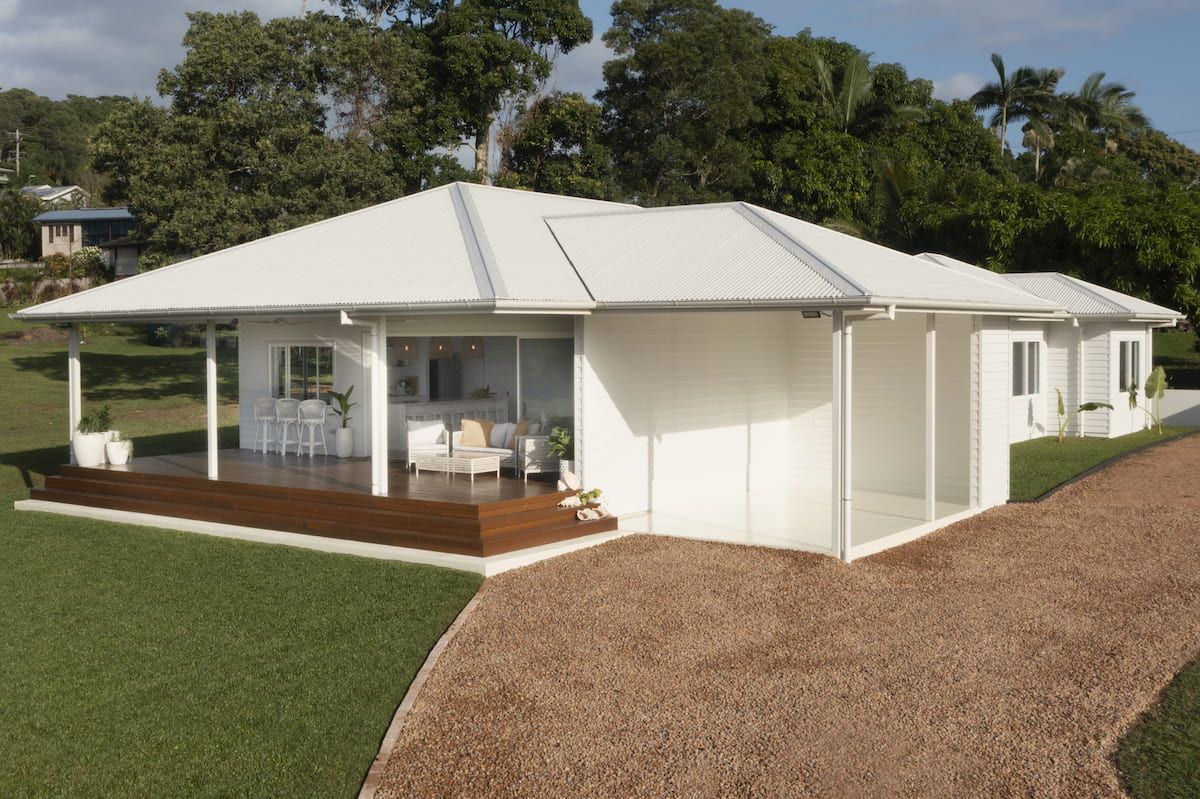 A white house with a driveway leading to it